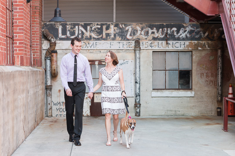 couple walking a dog, © Michelle and Sara Photography | American Tobacco Campus dog-friendly engagement photos