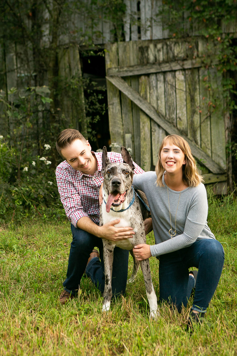merle Great Dane and his humans in front of old barn, love between dog and people, ©Mandy Whitley Nashville Pet Photography 
