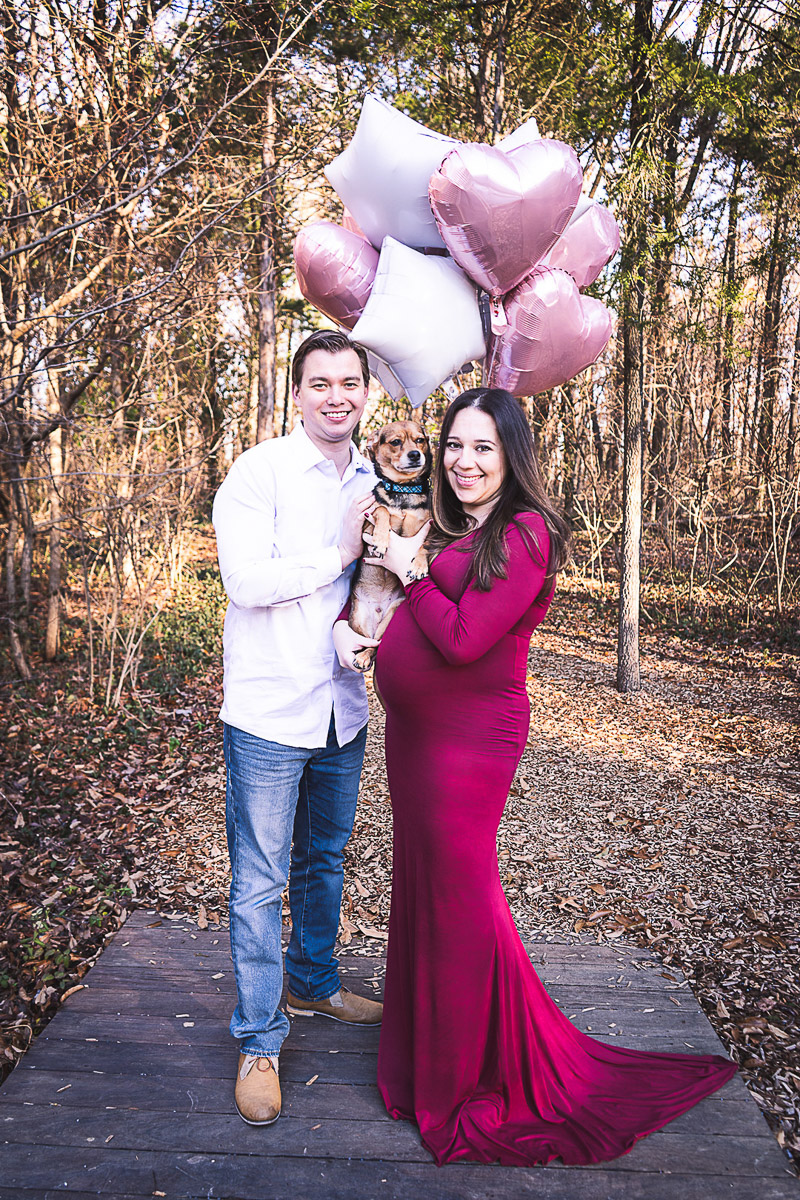 couple holding pink balloons and small mixed breed dog, dog friendly maternity session, ©Aim With Mia Photography