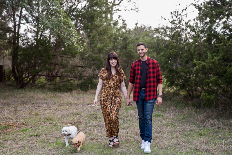 couple walking hand in hand with their small dogs, dog-friendly engagement ideas | ©Wildflower Barn Photography 