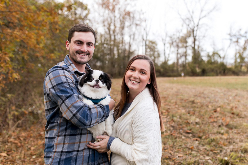 couple holding dog, fall engagement session | ©Autumn Howell Photography 