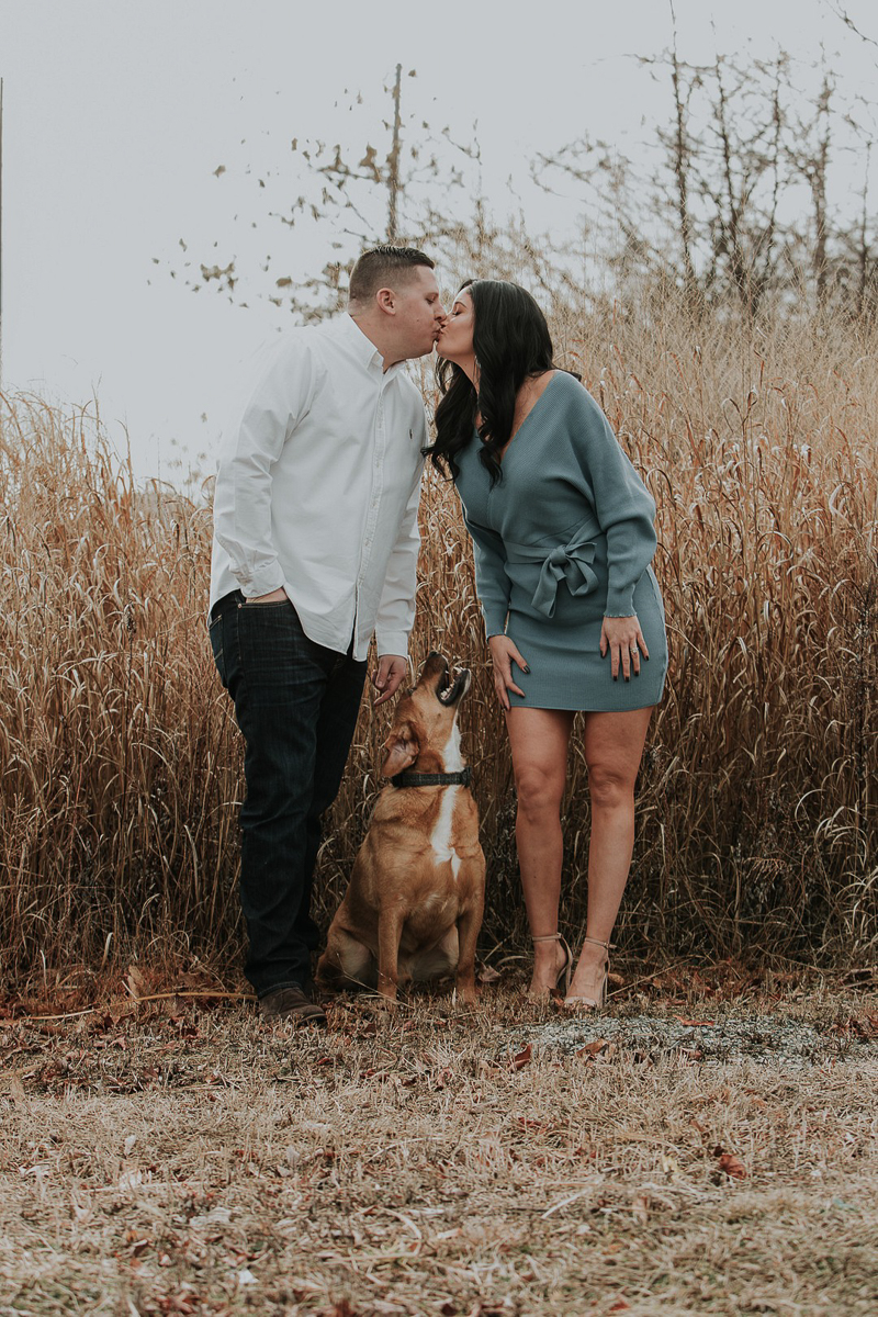 mixed breed dog looking at humans while they kiss, dog-friendly engagement photos, ©Kelli Wilke Photography |