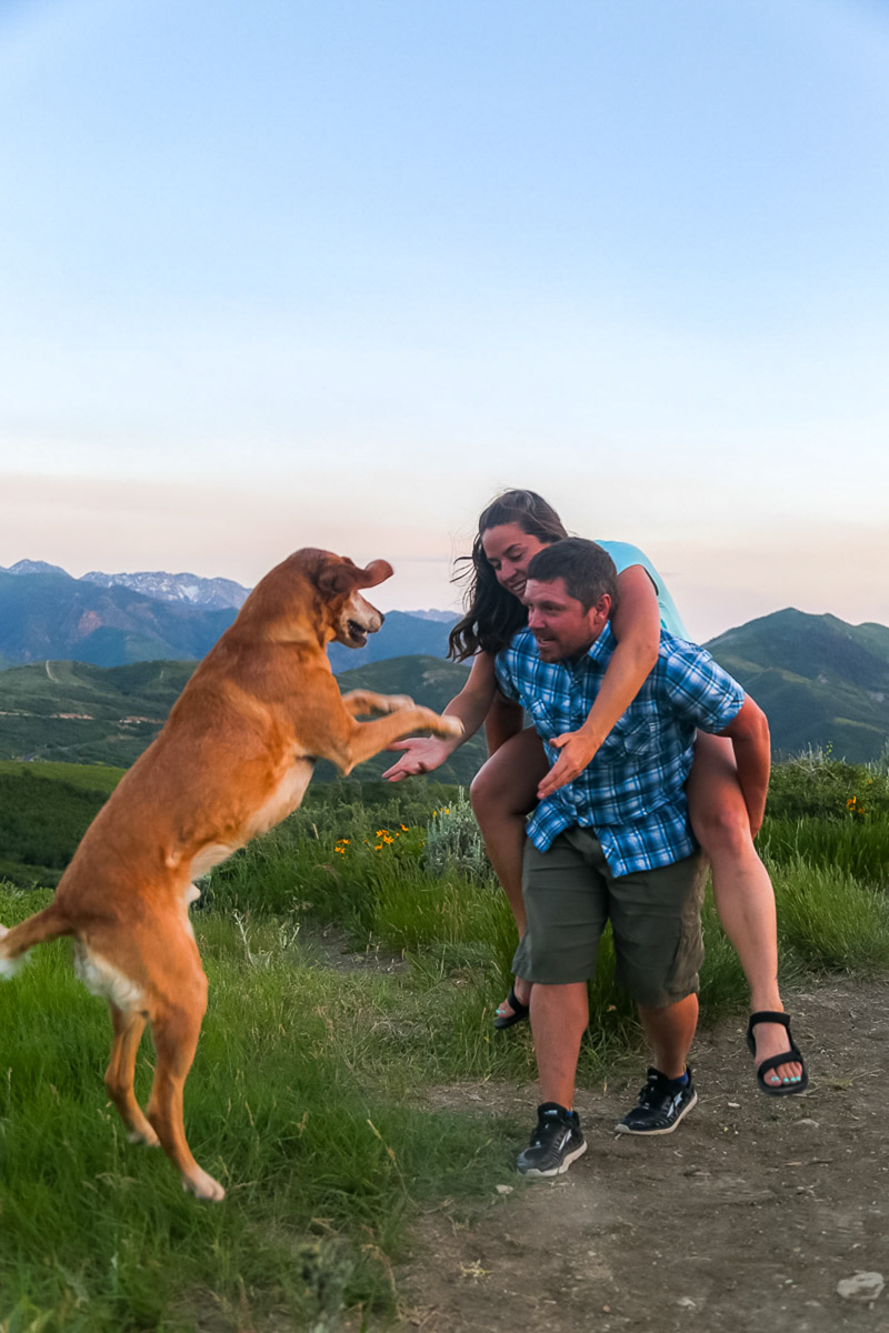 couple playing with dog, mountains in background, ©Halie West Photography | adventure dog photography