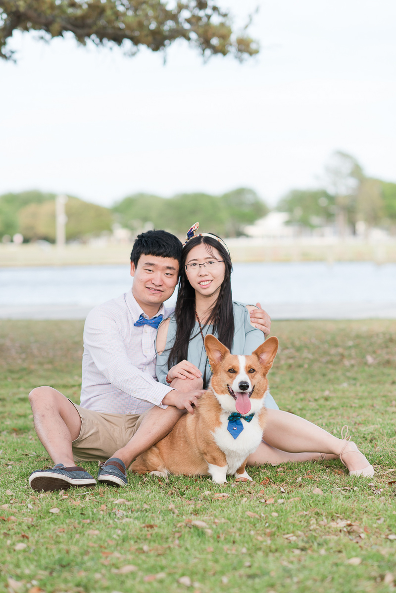 cute couple and their Corgi sitting on grass, Outer Banks photography session | ©Michelle & Sara Photography