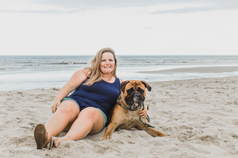 woman and her Bullmastiff at the beach | dog photoshoot ideas | ©Arli Quinn Photography