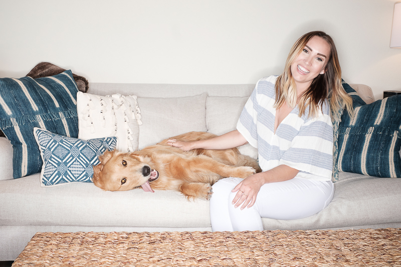 dog lounging on sofa with woman, love between people and dogs ©Nicole Caldwell Photo