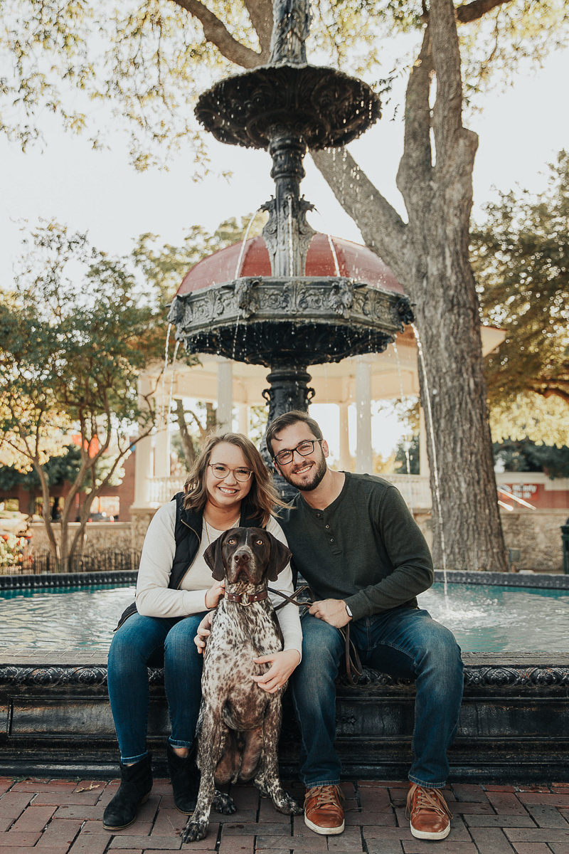 couple and German shorthaired pointer in front of fountain | Joshua and Parisa | Austin Wedding Photographer and Videographer
