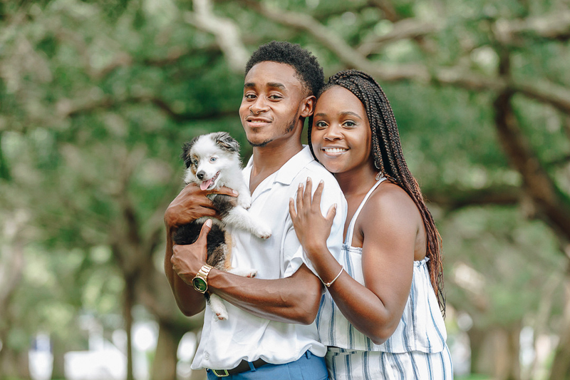 man holding small puppy, woman embracing man, ©Charleston Photo Art, LLC | dog-friendly portrait ideas