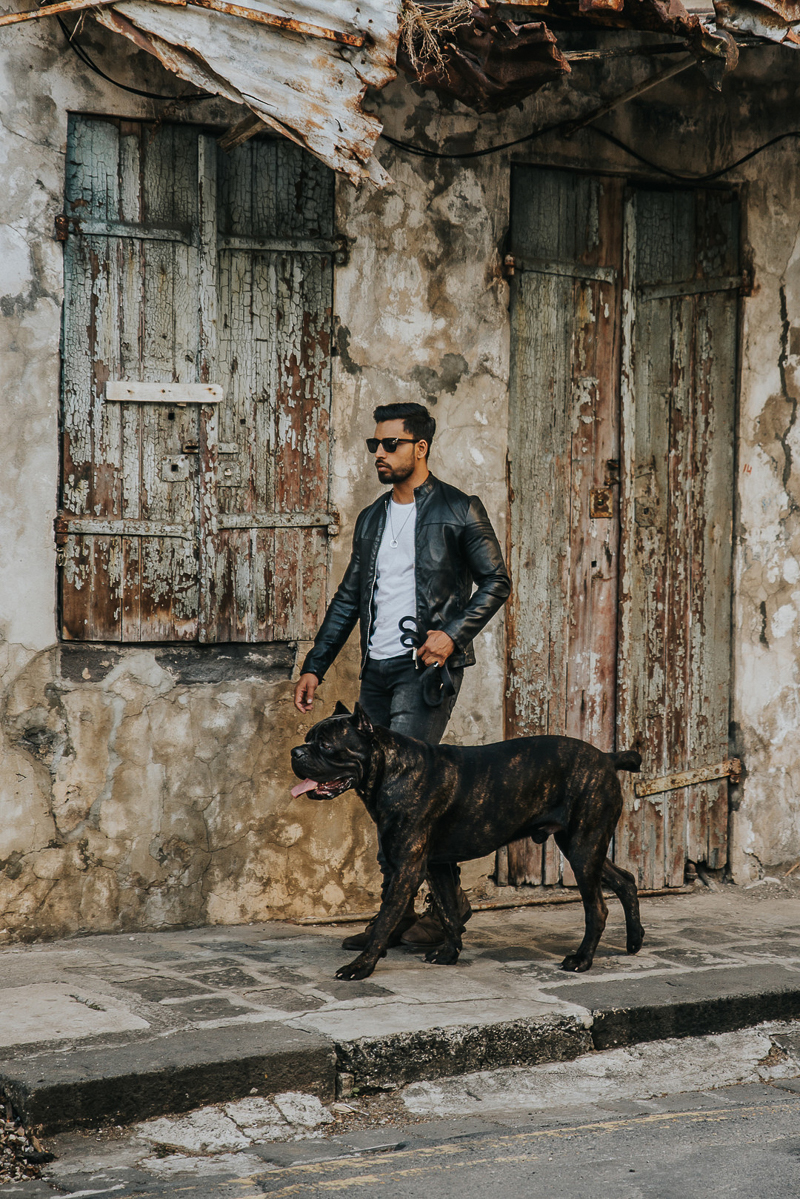 man in sunglasses and black leather jacket walking handsome dog | Cedric D Vincent Photography | Mauritius fashion photographer