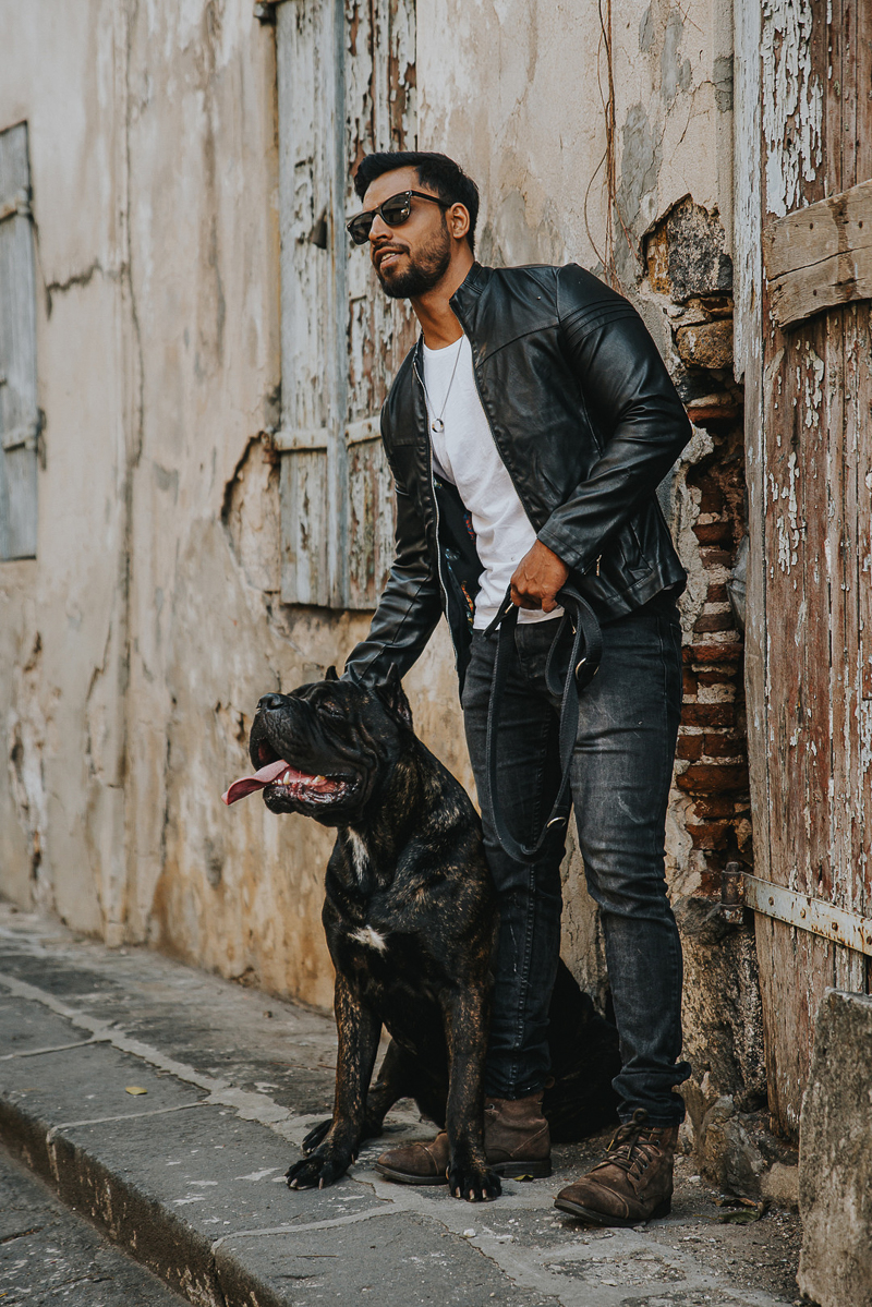 man in black jacket petting Cane Corso | Cedric D Vincent Photography | Mauritius fashion photographer