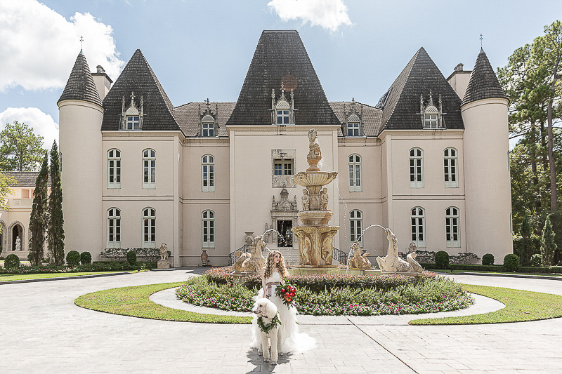 bride and poodle standing outside Chateau Cocomar | ©C. Baron Photography | dog-friendly bridal shoot, Houston, TX