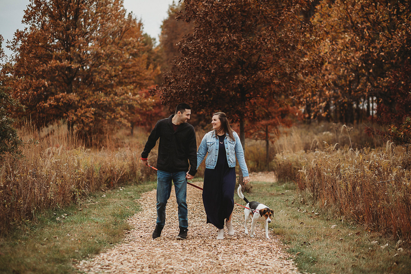 couple walking their dog while holding hands, fall photography ideas, ©Samantha Mitchell Photography | dog-friendly session