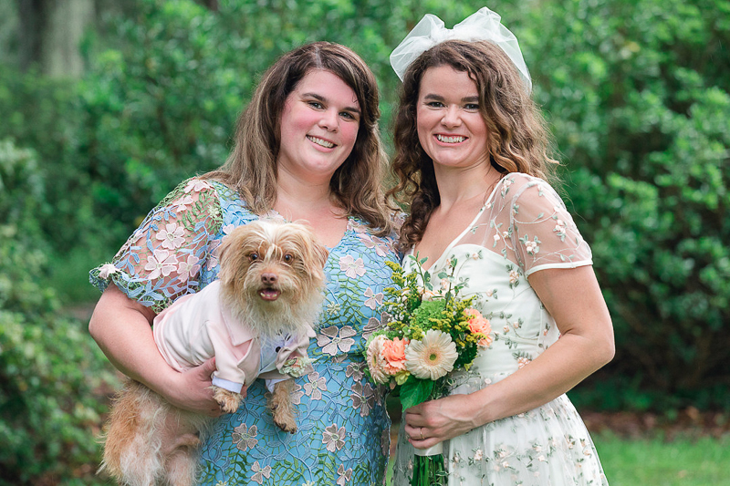 bridesmaid holding small dog, bride holding bouquet, small wedding | ©Charleston Photo Art