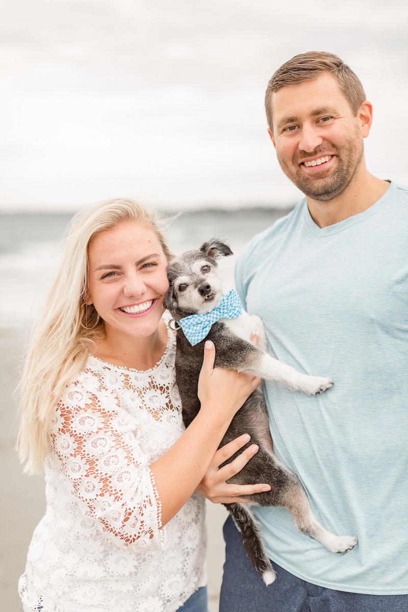 couple holding their cute mixed breed dog, engagement photos at the beach ©Coli Michael Photography 