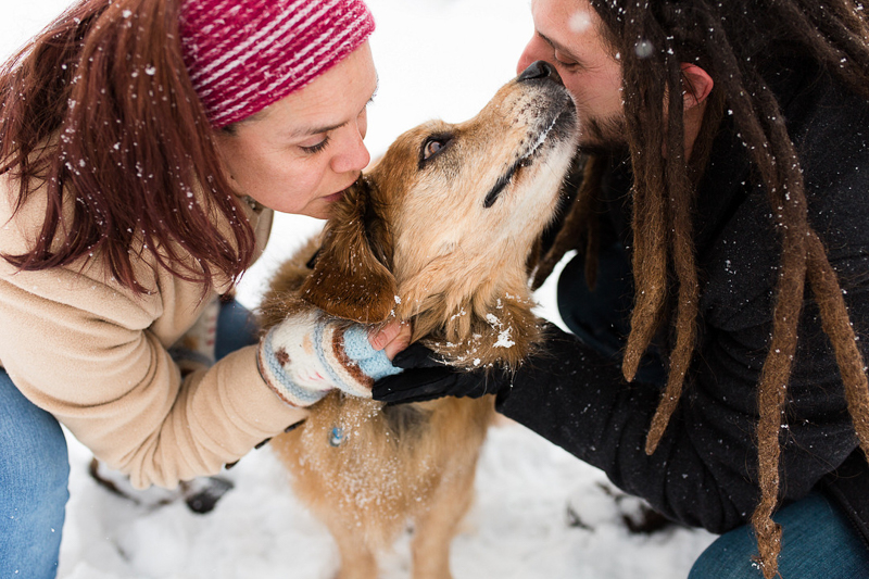 couple kissing their dog, snowy dog-friendly portraits | ©Megan Rei Photography | Bealeton, VA