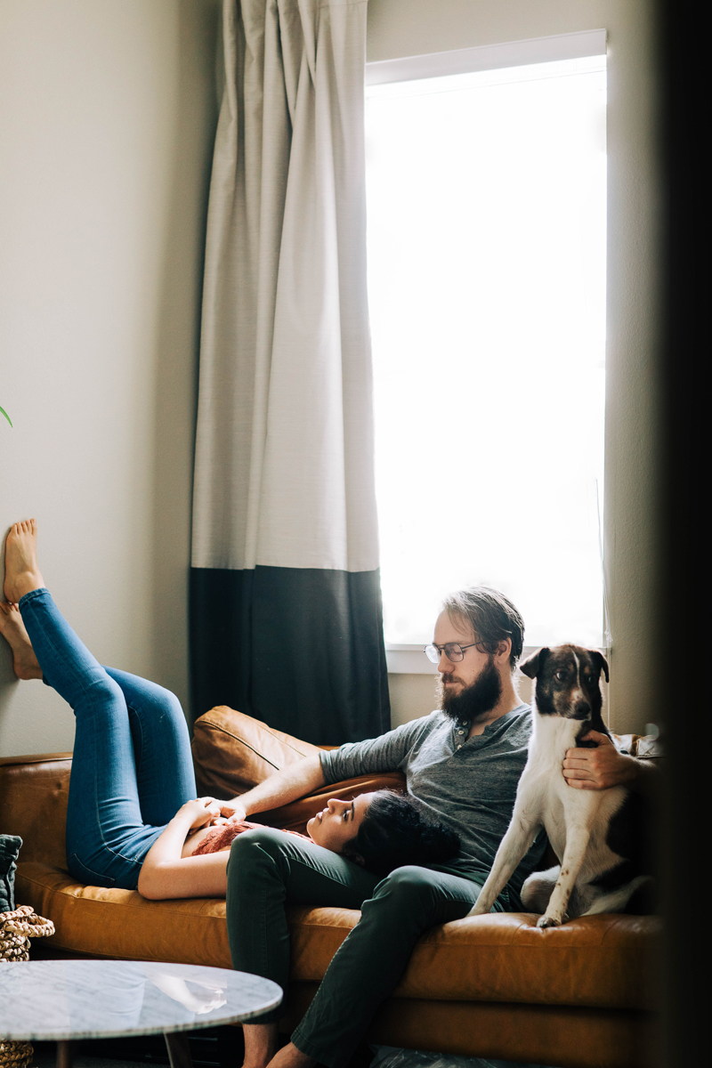 couple relaxing on sofa with their dog, lifestyle dog photography ideas | ©Sheena Shahangian Photography