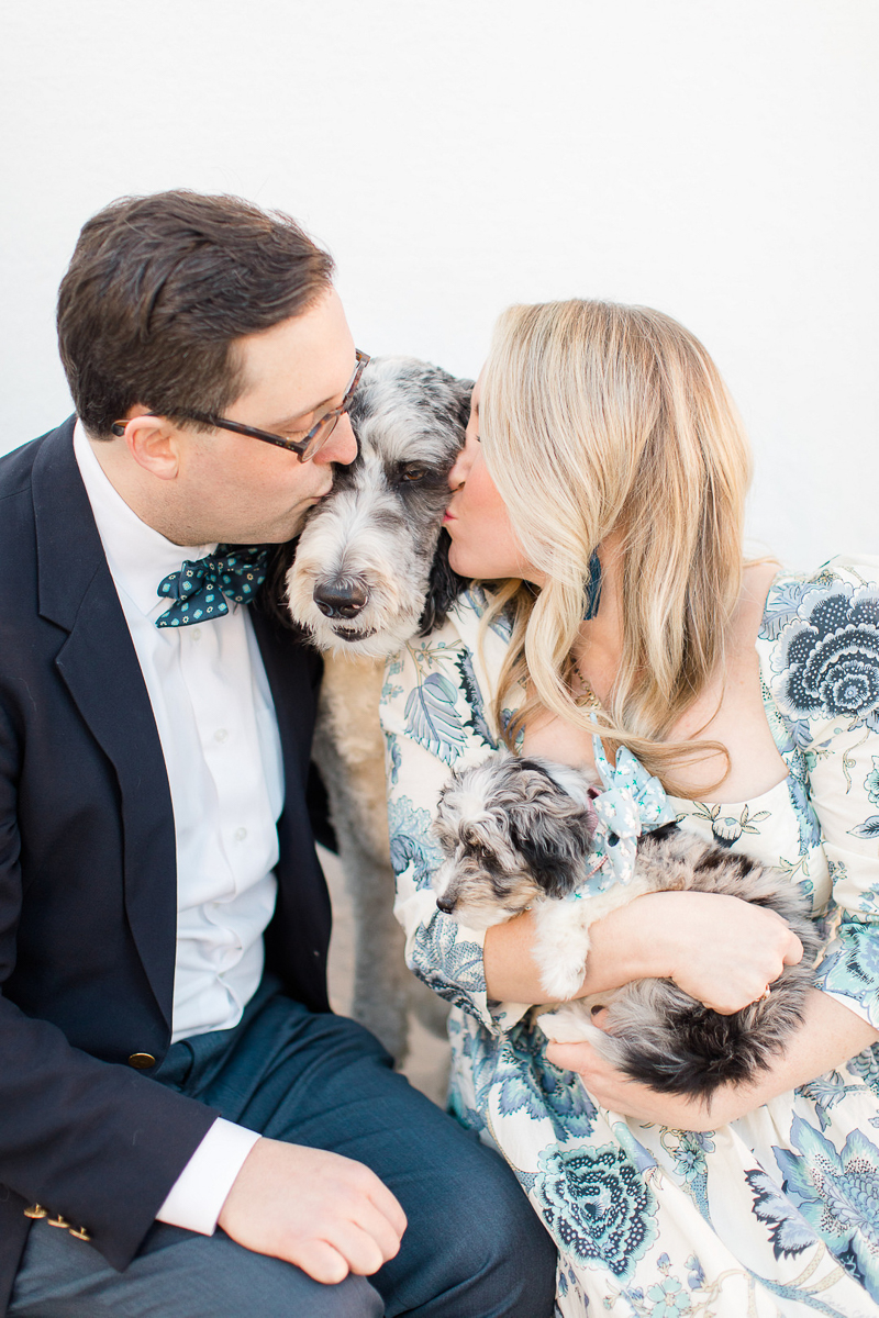 couple kissing Aussiedoodle, woman holding another Aussiedoodle puppy, dog-friendly family photos | ©Christa Rene Photography