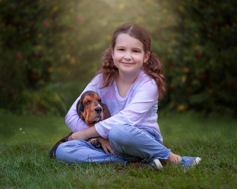 little girl with arms gently wrapped around puppy, kids and dogs portrait ideas | ©Terri J Photography