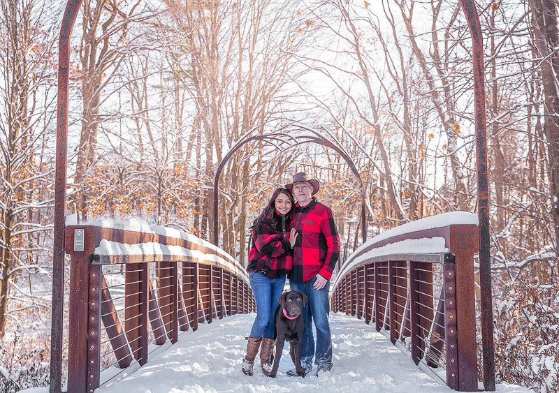 couple and their dog standing on snow covered bridge, Richmond Hill, Ontario | © Terri J Photography