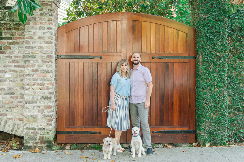 couple and their dogs in front of arched wood gate, ©Charleston Photo Art, dog-friendly family portraits 