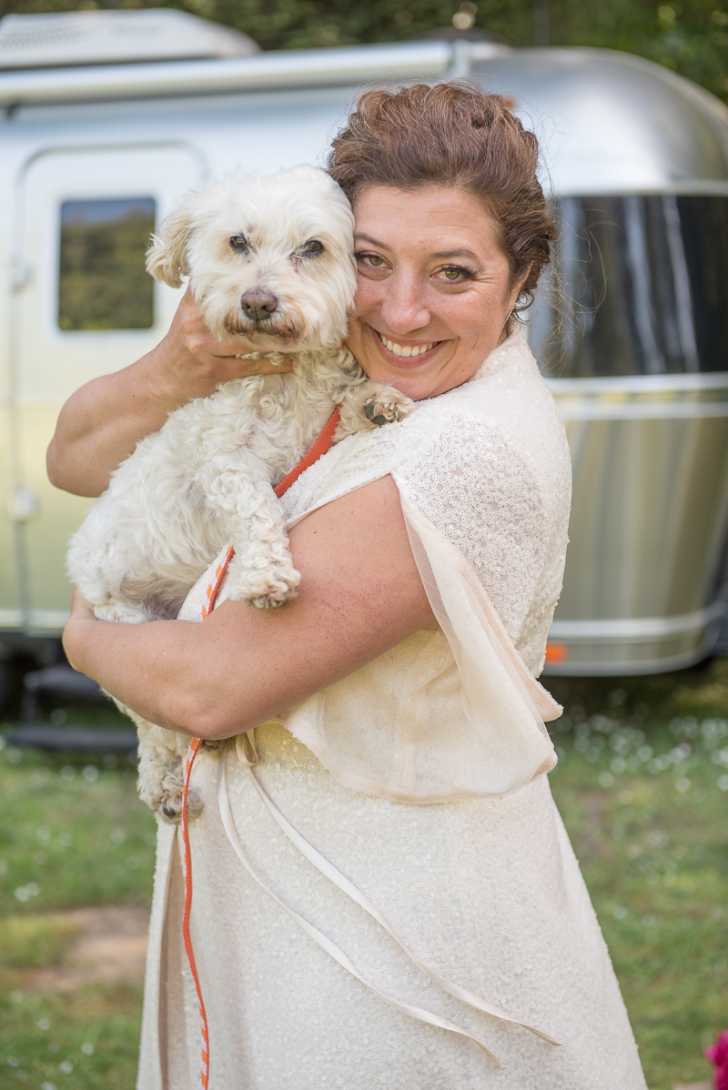 bride in long dress holding white dog, Rustically Romantic Photography by Darby Johnson