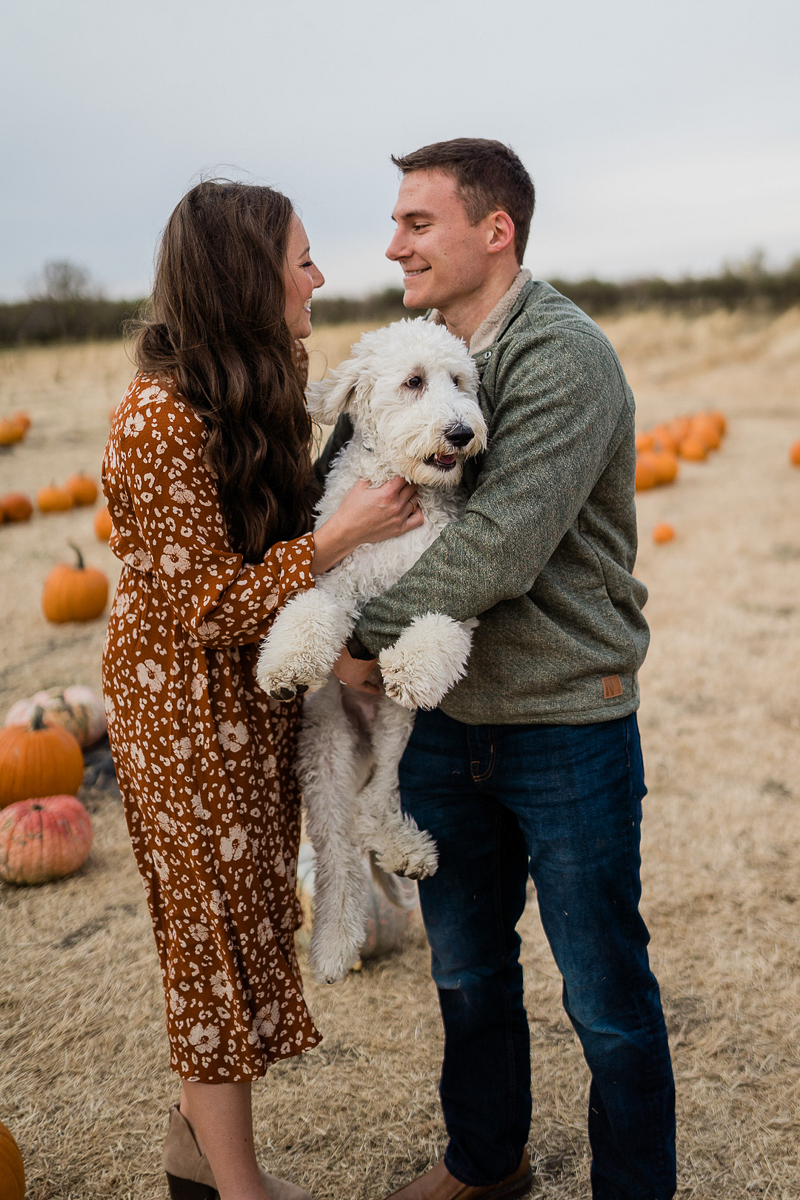 fall family photos with dog in pumpkin patch | ©Erica Jane Photography