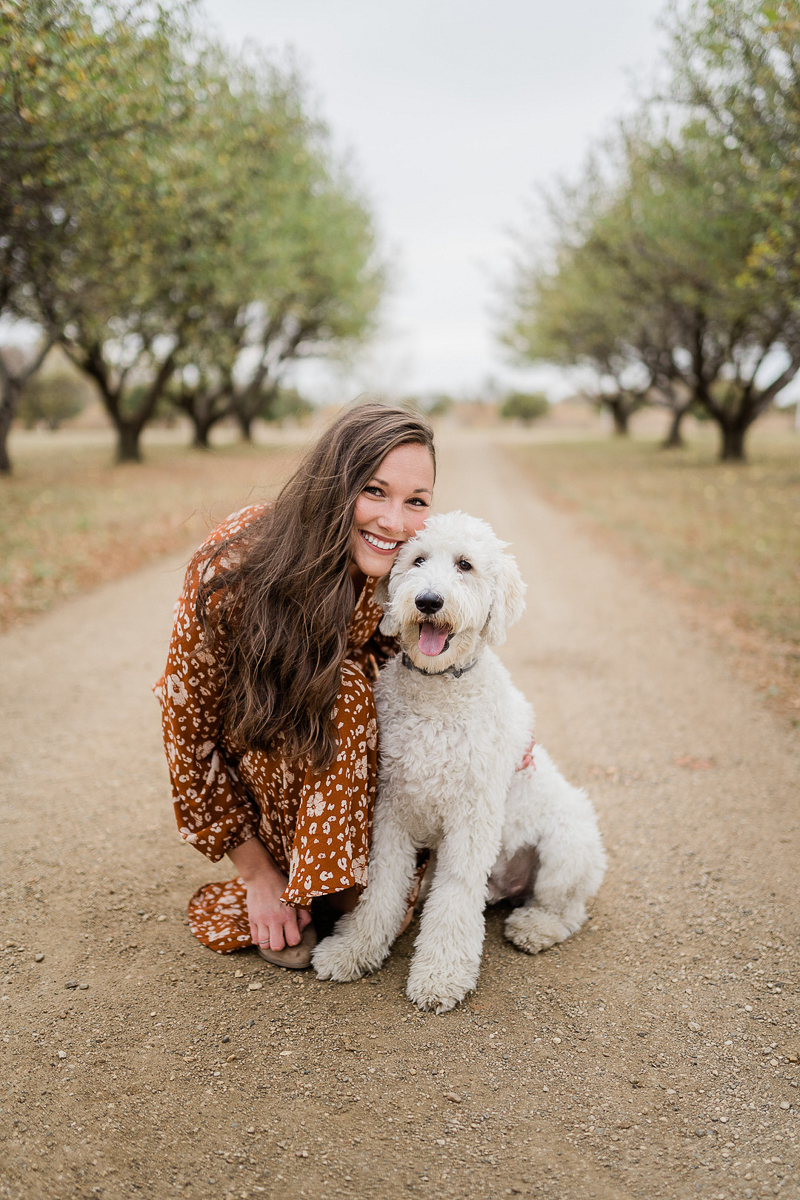 fall family photos with dog in orchard ©Erica Jane Photography