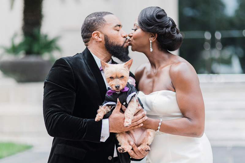just married couple kissing while holding their dog, Yorkie in tux | ©Pharris Photography, Houston, Texas. The Savvy Consultant
