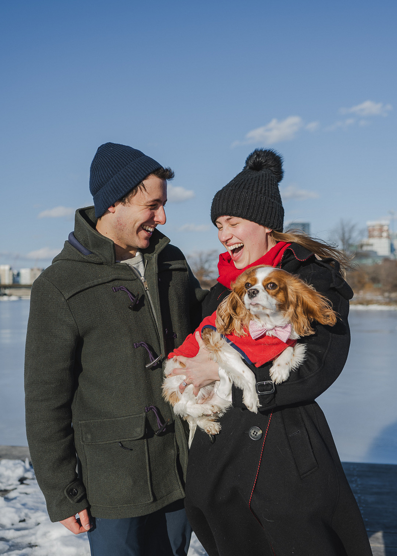 happy couple holding Cavalier spaniel | ©Amanda Macchia Photography | dog-friendly engagement session