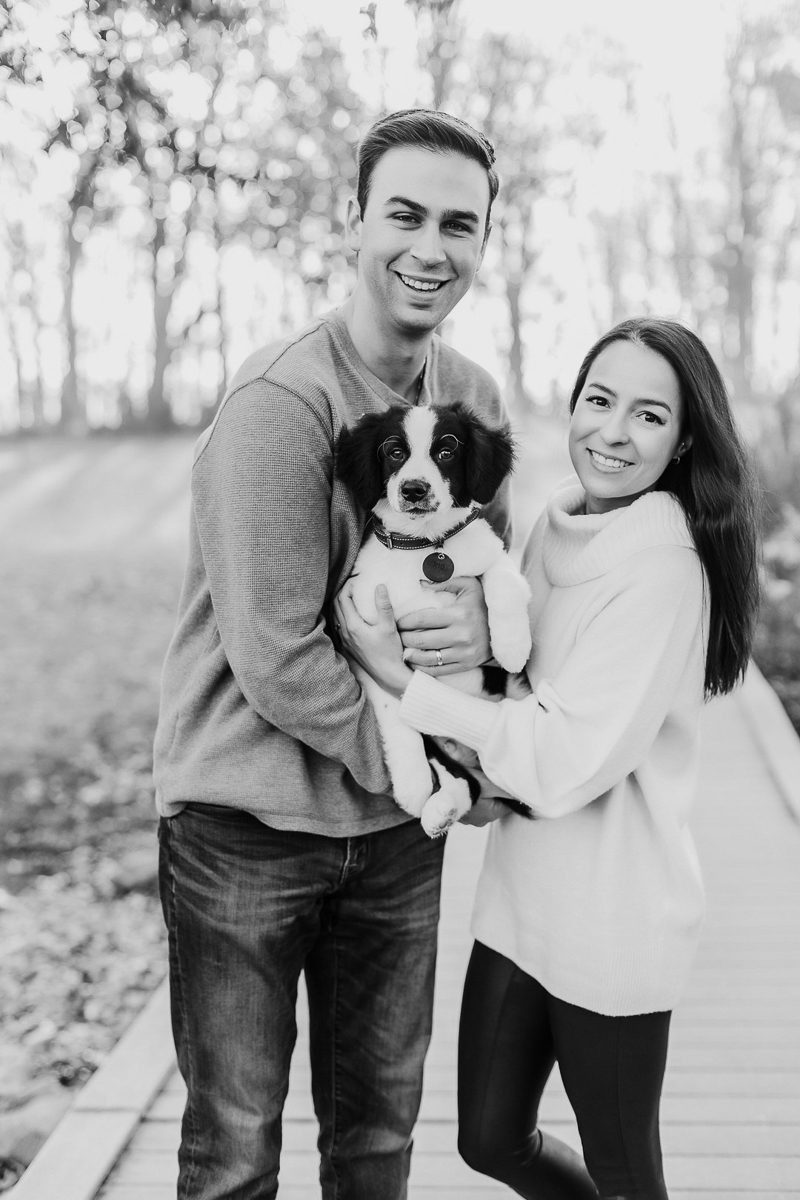 couple holding their puppy, black and white timeless family portraits | ©Samantha Mitchell Photography