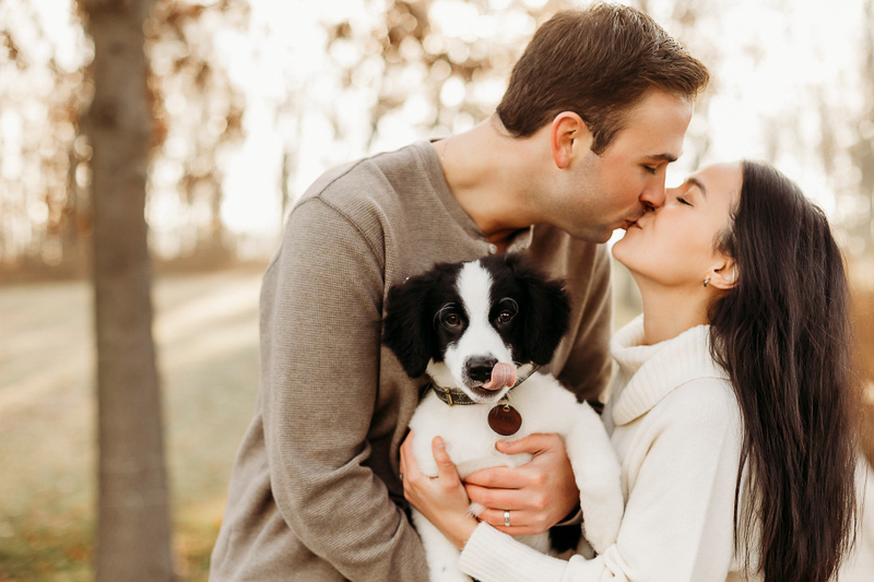 dog photography ideas, couple kissing while holding Border Collie mix | ©Samantha Mitchell Photography
