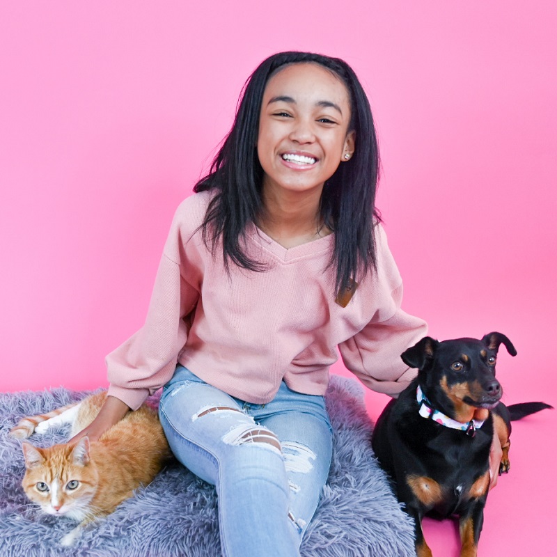 Founder of Ava's Pet Palace, girl with her dog and cat