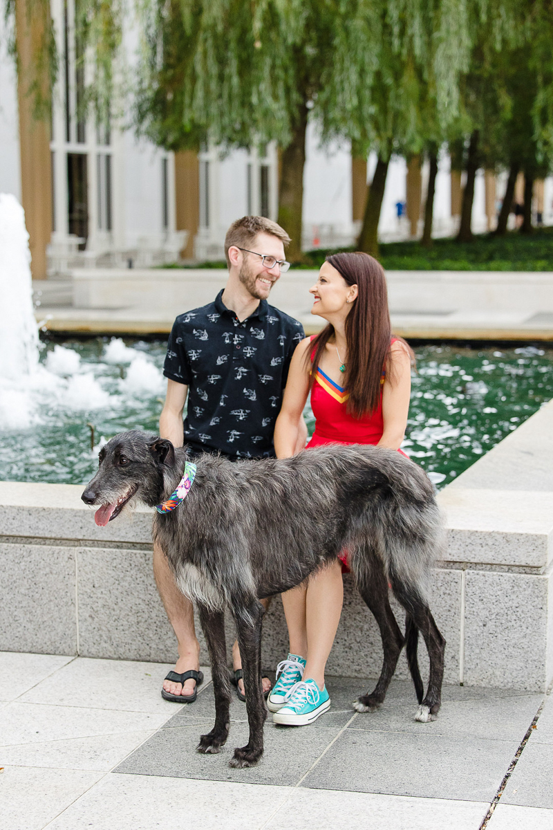 couple sitting with their dog at fountain at Kennedy Center | ©Megan Rei Photography