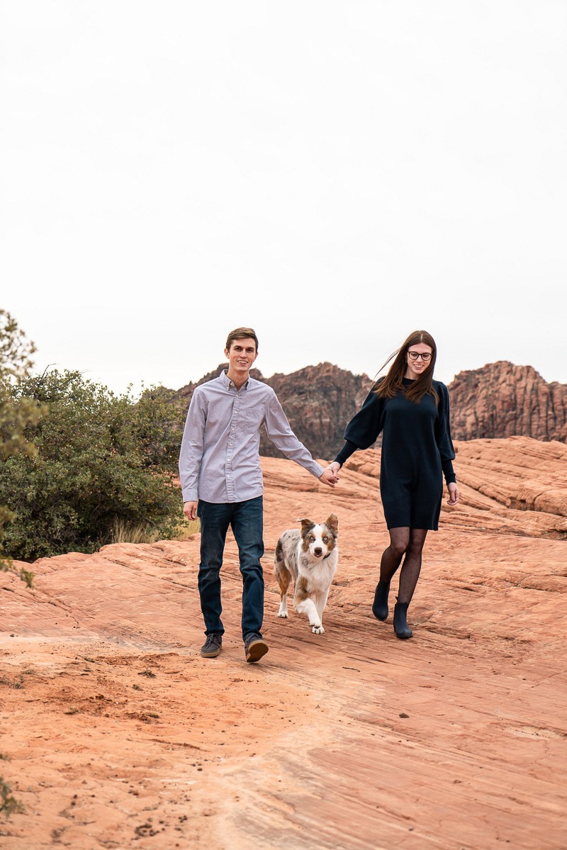 couple walking dog in red sand, Snow Canyon State Park | ©AW Creates