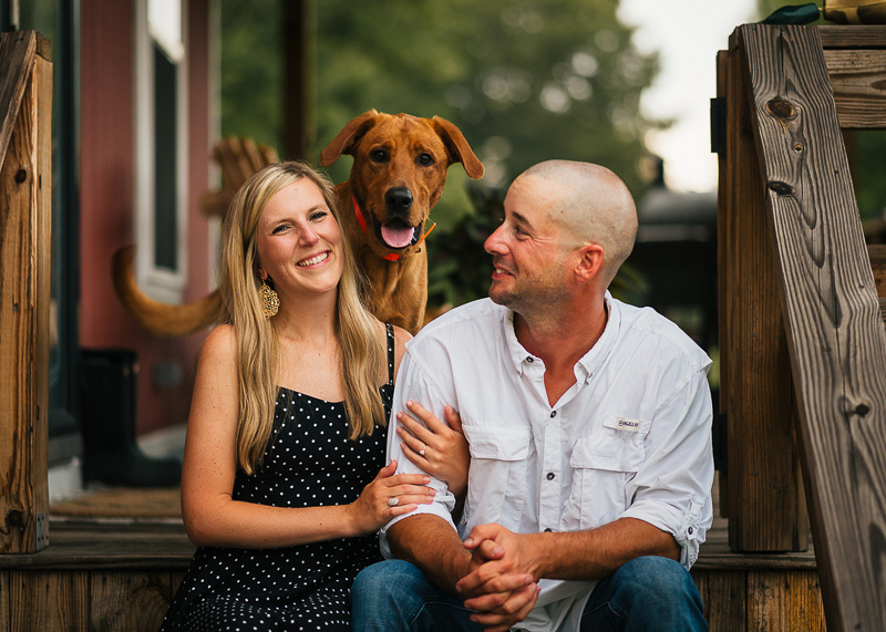 Red Labrador Retriever standing behind couple sitting on stairs | ©Memories By Lexi