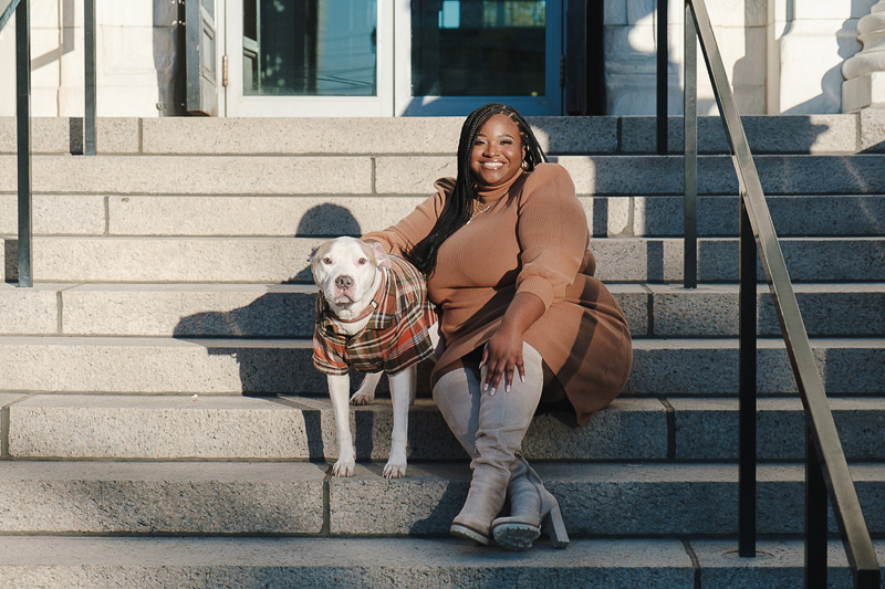 woman wearing brown dress sitting on steps with her dog | ©Austin Garnette Photography