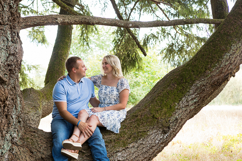couple sitting on large tree trunk | | ©Photography by Cambrae
