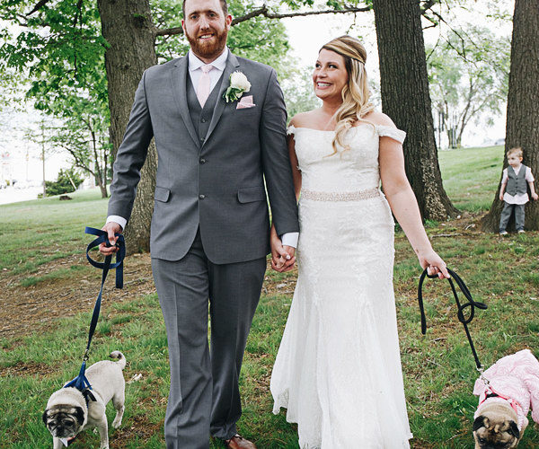 bride and groom walking with their Pugs in Park | ©Please Don't Blink Photography