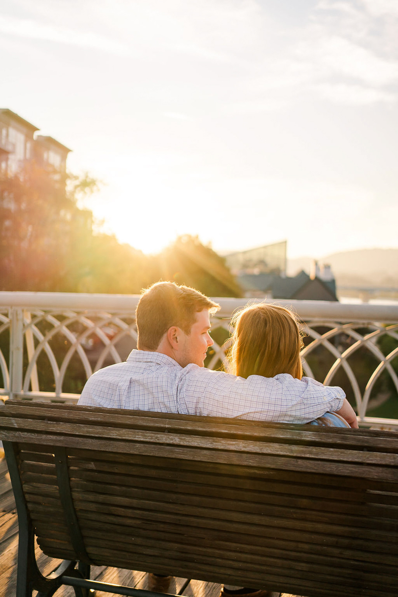 couple sitting on bench, romantic engagement session | ©Sarah Larae Photography