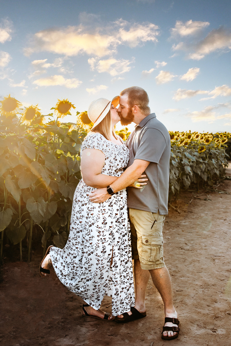couple kissing in sunflower field |©Ashley Kalbus Photography