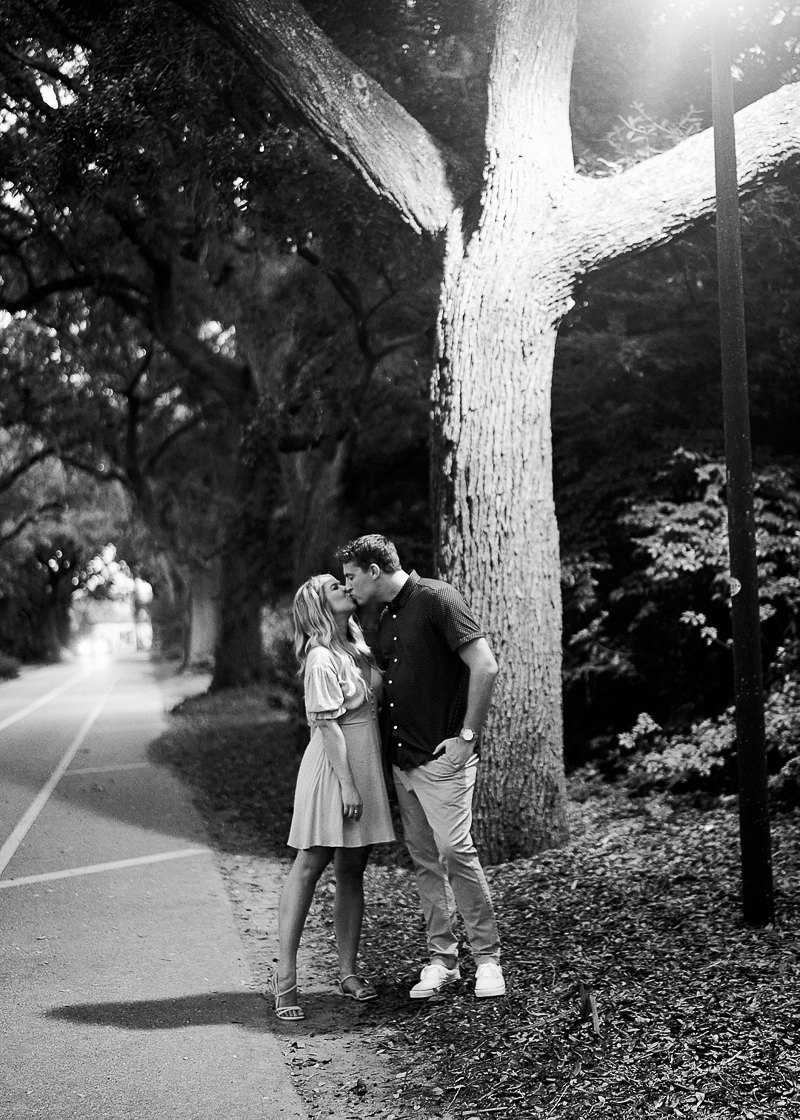 black and white image of engaged couple under the lamppost, ©Cushla Beasley Wedding Photography-dog-friendly engagement, Charleston, SC