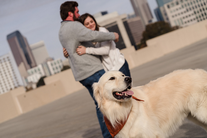 dog-friendly engagement photo taken throug dog-friendly engagement photos on parking garage roof ©Party of Two Photography
