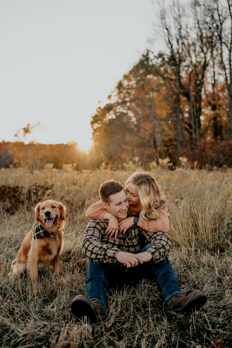 couple and their dogs sitting in a field, dog-friendly engagement photos | ©Mindy Hulett Photography, Sterling, NY
