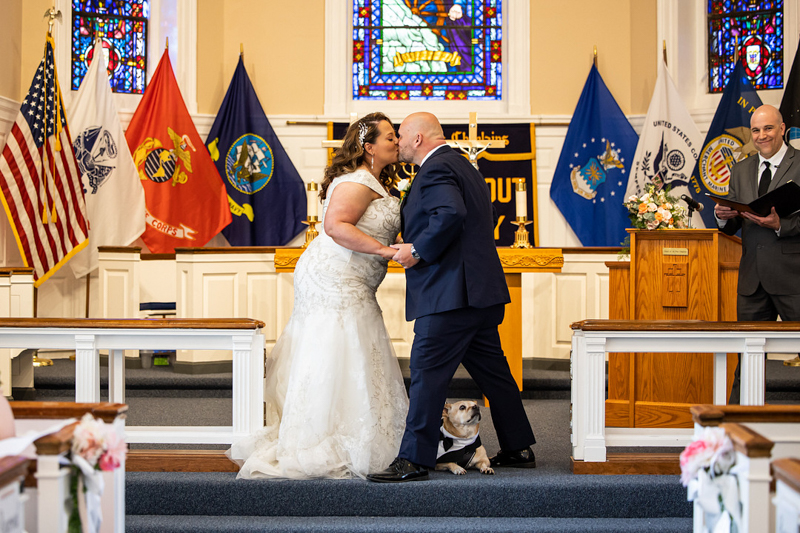 just married, bride and groom's first kiss, dog at the altar, ©ProPhoto by MK