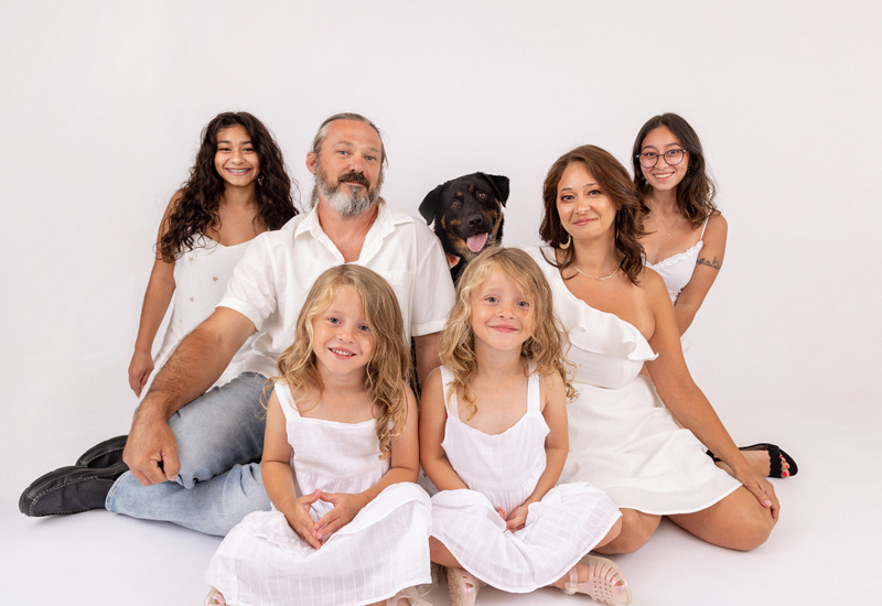 dog-friendly studio family portraits, couple and their 4 daughters wearing white on white background and their dog |©Mia Lee Photography