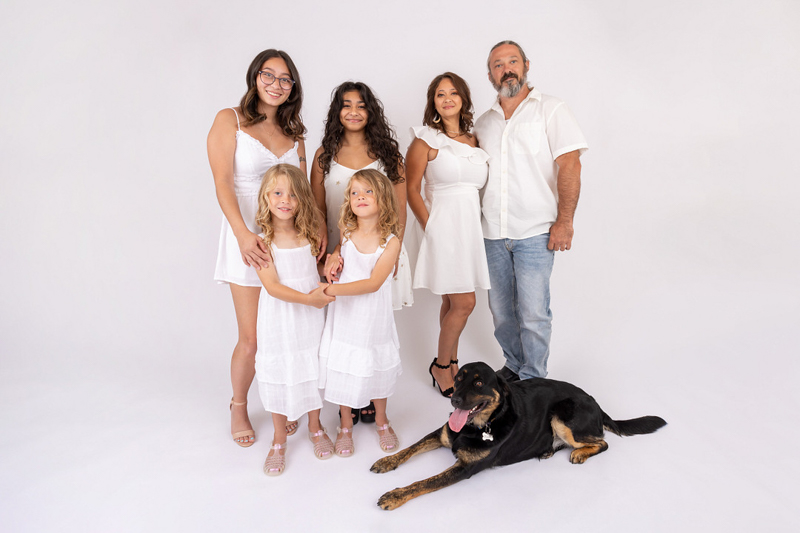 dog-friendly studio family portraits, couple and their 4 daughters wearing white on white background and their dog |©Mia Lee Photography
