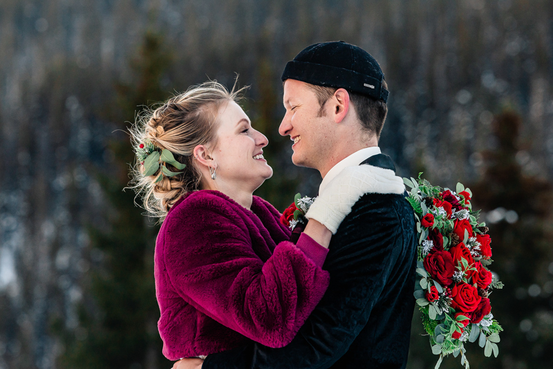 Rocky Mountain elopement ©The Outlovers, bride wearing fuzzy maroon jacket